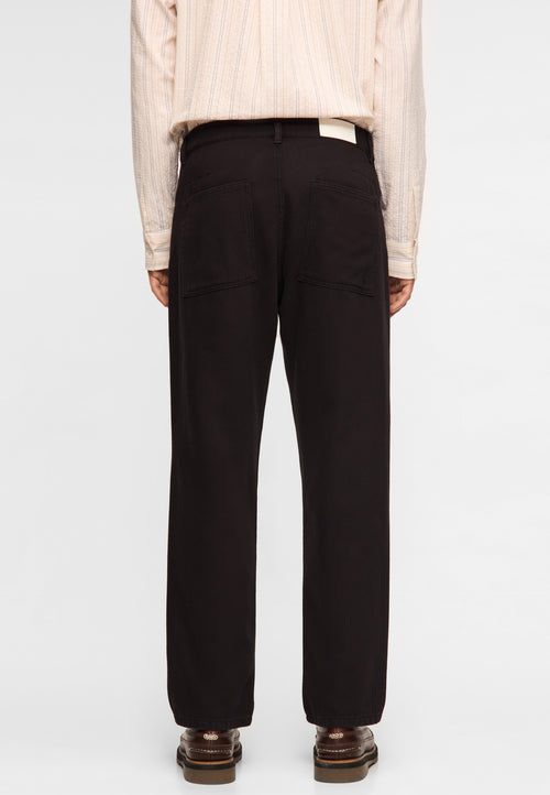 Garment-dyed tapered jeans black