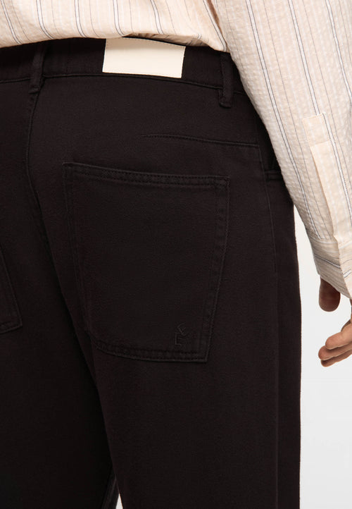 Garment-dyed tapered jeans black